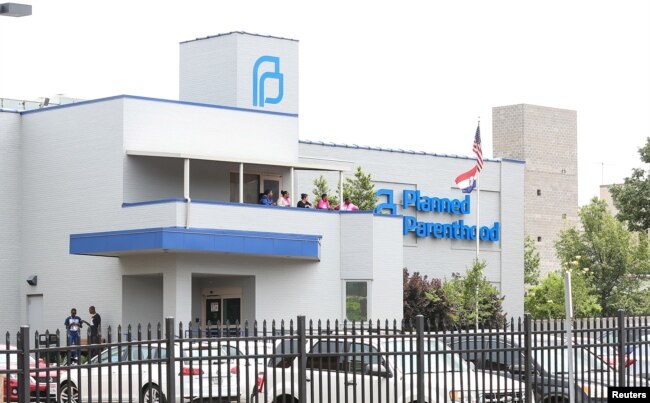 Planned Parenthood employees watch pro-choice and pro-life supporters protest as a deadline looms to renew the license of Missouri's sole remaining Planned Parenthood clinic in St. Louis, Missouri, May 31, 2019.