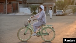 Amirah al-Turkistani, a graphic design lecturer at Jeddah International College, rides her bicycle in Jeddah, Saudi Arabia, November 7, 2017