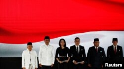 Indonesia's President Joko Widodo, his running mate Ma'ruf Amin, presidential candidate Prabowo Subianto and his running mate Sandiago Uno sing the national anthem before their last presidential debate in Jakarta, Indonesia April 13, 2019.