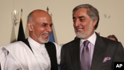 Afghan presidential candidate Ashraf Ghani Ahmadzai, left, and Afghan presidential candidate, Abdullah Abdullah right, are laughing during a joint press conference in Kabul, Afghanistan, Saturday, July 12, 2014. 