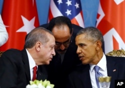 FILE - Turkish President Recep Tayyip Erdogan, left, and U.S. President Barack Obama chat during a session of the G-20 Summit in Antalya, Turkey, Nov. 15, 2015.