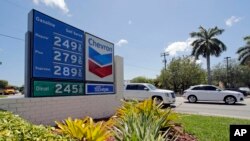 This May 3, 2017, photo shows a a sign with gas prices at a Chevron station in Miami, Florida.