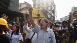 Myanmar, Yangon, People shout slogans during a protest against the military coup