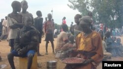 A displaced South Sudanese woman prepares a meal in a camp for internally displaced people in the UNMISS compound in Tomping, Juba, South Sudan, July 12, 2016.