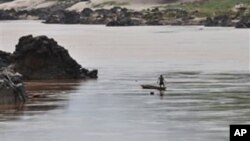 A fisherman works near the site of the proposed Xayaburi Dam in Paksey, northern Laos, file photo. 