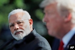 FILE - Indian Prime Minister Narendra Modi looks toward President Donald Trump as he speaks in the Rose Garden at the White House.