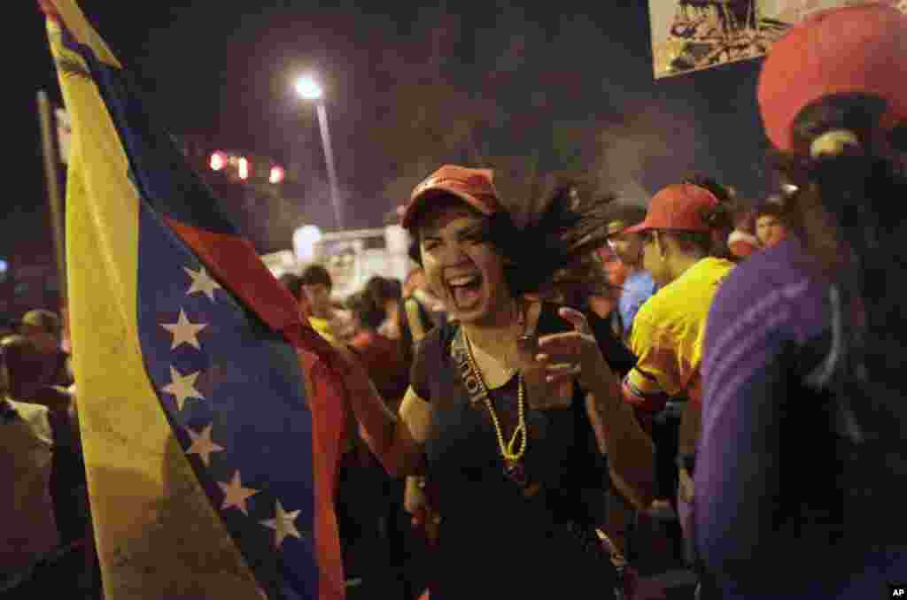 Government supporters celebrate after the official results of the presidential elections were announced at the Miraflores Palace in Caracas, Venezuela early Monday. 