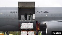 FILE - A shipment of Johnson & Johnson vaccines against the coronavirus disease, donated by the U.S., is unloaded in Bogota, Colombia, July 1, 2021. It was announced Jan. 28, 2022, that the U.S. had now shipped 400 million doses of vaccine to 112 countries.