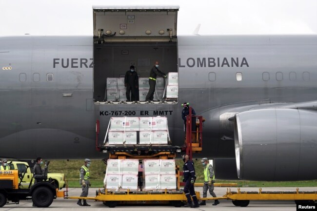 FILE - A shipment of Johnson & Johnson vaccines against the coronavirus disease, donated by the U.S., is unloaded in Bogota, Colombia, July 1, 2021. (REUTERS/Nathalia Angarita)