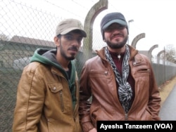 Syrians Ahmad Hamdan and Abdulnasir Tahir outside a camp migrants camp near Giessen, Germany.