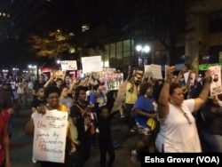 Protesters, marching for a fourth night after an African-American man was shot to death by police on Tuesday, chant, "Hands up, don't shoot," as they walk, in Charlotte, North Carolina, Sept. 23, 2016.