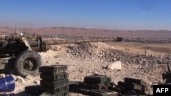Canon aims at rebel positions in strategic rebel-held Yabroud area, near Damascus, Feb. 15, 2014.
