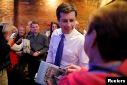 FILE - Democratic 2020 U.S. presidential candidate Pete Buttigieg greets voters during a campaign stop at Portsmouth Gas Light, in Portsmouth, N.H., March 8, 2019.