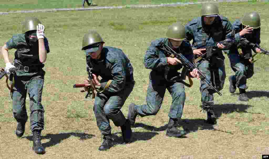 Recruits take part in military exercises in the shooting range of the Ukrainian National Guard near the village of Novy-Petrivtsi not far from Kyiv .