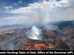 Fire activity is seen near Parowan, during a tour by Utah Lt. Gov. Spencer Cox, in southern Utah, June 26, 2017. The nation's largest wildfire has forced more than 1,500 people from their homes and cabins in a southern Utah mountain area home to a ski town and popular fishing lake.