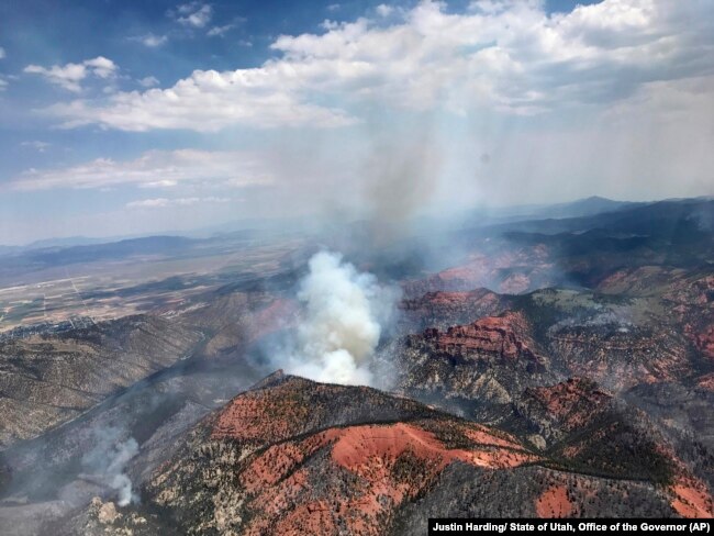 Fire activity is seen near Parowan, during a tour by Utah Lt. Gov. Spencer Cox, in southern Utah, June 26, 2017. The nation's largest wildfire has forced more than 1,500 people from their homes and cabins in a southern Utah mountain area home to a ski town and popular fishing lake.