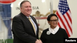 U.S. Secretary of State Mike Pompeo shakes hands with Indonesian Foreign Minister Retno Marsudi during their meeting in Jakarta, Indonesia, Aug. 4, 2018.