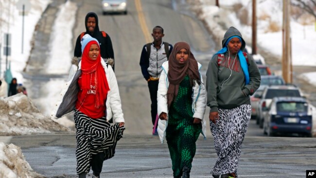 FILE - Students walk home from school in Lewiston, Maine, Jan. 26, 2016. Since February 2000, more than 5,000 Africans have come to Lewiston; now, many Somali shops, restaurants and mosques serve the city.