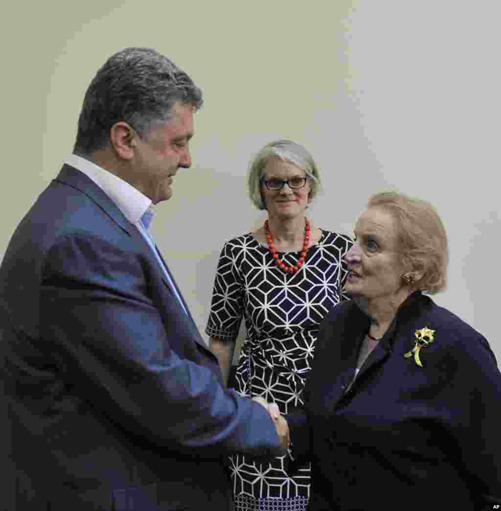 Ukrainian presidential candidate Petro Poroshenko and former U.S.Secretary of State Madeleine Albright, shake hands during a meeting in Kyiv, May 24, 2014.