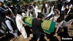 FILE - Afghans take part in a burial ceremony of Afghan journalist Zabihullah Tamanna, in Kabul, Afghanistan, June 7, 2016. 