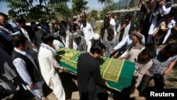 FILE - Afghans take part in a burial ceremony for journalist Zabihullah Tamanna, in Kabul, Afghanistan, June 7, 2016. Tamanna was an interpreter for NPR photojournalist David Gilkey. Both were killed in early June.