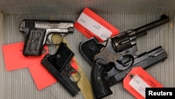 FILE - Handguns given up by the public as part of a gun turn-in where a gift card is given for every firearm turned over to Chicago Police are seen in a box at Universal Missionary Baptist Church in Chicago, Illinois, May 28, 2016.
