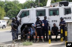 Police stand guard at the entrance of the Ghana electoral commission office in Accra, Ghana, Dec. 9, 2016.