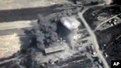 In this photo made from the footage taken from Russian Defense Ministry official web site on Oct. 4, 2015, an aerial view of a bomb explosion in Syria. 