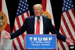 Republican presidential candidate Donald Trump gestures during a campaign speech in Tampa, Fla., June 11, 2016.