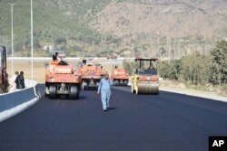 FILE - Road construction is underway as part of China's Belt and Road Initiative, in Haripur, Pakistan, Dec. 22, 2017.