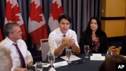 Prime Minister Justin Trudeau (C) addresses a gathering during a roundtable discussion with members of the Canadian Technology Accelerator in Cambridge, Mass., May 17, 2018. 