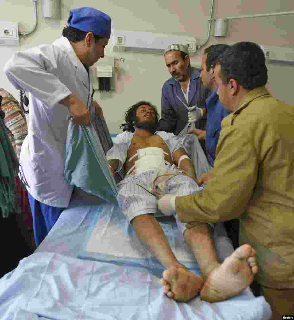 Medics treat a man, who was wounded during a suicide attack at a volleyball match on Sunday in the Yahya Khel district of Paktika province, at a military hospital in Kabul, Nov. 24, 2014