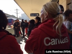 Austrian relief workers await thousands of refugees arriving at the Vienna train station from the Hungarian border, Sept. 6, 2015.