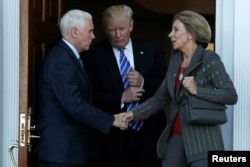 FILE - U.S. President-elect Donald Trump and Vice President-elect Mike Pence emerge with Betsy DeVos after their meeting at the main clubhouse at Trump National Golf Club in Bedminster, N.J. Nov. 19, 2016.