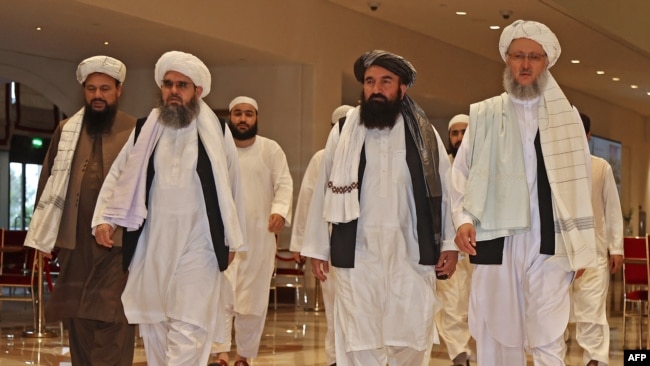 FILE - Taliban officials walk down a hotel lobby during talks in Doha, Qatar, Aug. 12, 2021. The Taliban and the United States ended two days of meetings in Qatar on Nov. 30, 2021.