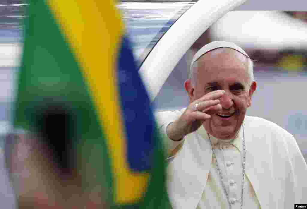Pope Francis waves to the faithful as he arrives at Sao Joaquim Palace in Rio de Janeiro, July 26, 2013.&nbsp;