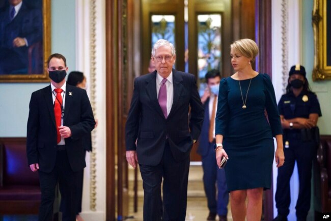 Senate Minority Leader Mitch McConnell, R-Ky., returns to his office from the Senate chamber before votes, at the Capitol in Washington, Sept. 30, 2021.