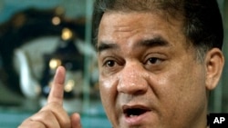 FILE - Ilham Tohti, a champion of China's Uighur minority, gestures during an interview in his Beijing home, Feb. 4, 2013.