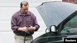 FILE - James Everett Dutschke works on his minivan in his driveway in Tupelo, Mississippi, April 2013.