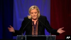 Far right National Front party leader Marine Le Pen delivers a speech after the announcement of partial results in the second round of regional elections, in Henin-Beaumont, northern France, Dec.13, 2015.