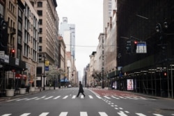 UA man crosses a nearly empty 5th Avenue in midtown Manhattan during the outbreak of the coronavirus disease (COVID-19) in New York City, New York, U.S., March 25, 2020. (REUTERS/Mike Segar)