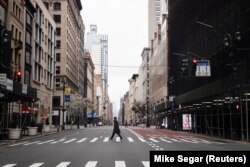 UA man crosses a nearly empty 5th Avenue in midtown Manhattan during the outbreak of the coronavirus disease (COVID-19) in New York City, New York, U.S., March 25, 2020. (REUTERS/Mike Segar)