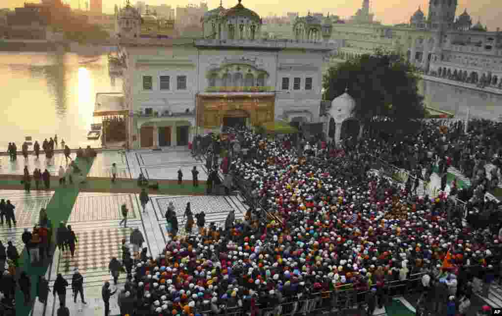 Sikh devotees throng to the Golden Temple in Amritsar, India, Jan. 1, 2014. 