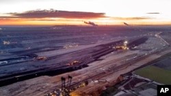 FILE - Bucket wheel excavators are mining coal at the Garzweiler open-cast coal mine in Luetzerath, Germany, Oct.25, 2021.