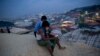 Rohingya Muslims use their cellphones as they sit on a hillock overlooking Balukhali refugee camp, in Bangladesh, Nov. 14, 2018. 