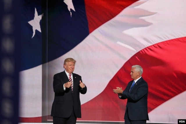 Republican presidential nominee Donald Trump, left, gives his running mate, Indiana Governor Mike Pence, a thumbs up after Pence addressed the Republican National Convention.