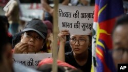 Exile Tibetans listen to a speaker during a protest to show support with India's Doklam standoff in New Delhi, India, Aug. 11, 2017.