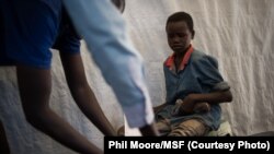 A boy has an infected wound cleaned in the dressings tent of a Médecins Sans Frontières (MSF) clinic set up at the camp for displaced people in the grounds of the United Nations Mission to South Sudan (UNMISS) base in Juba, South Sudan, on January 12, 2014.
