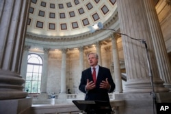 FILE - Senator John Hoeven, R-N.D., responds to questions during a TV news interview on Capitol Hill in Washington, July 11, 2017.