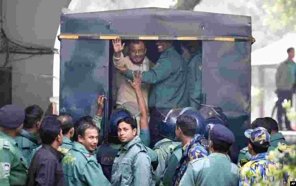 A.T.M. Azharul Islam, assistant secretary general of the Jamaat-e-Islami party, waves his hand as he enters a police van after a special tribunal sentenced him to death in Dhaka, Bangladesh. A special tribunal has sentenced the senior Islamist party leader to death for leading a militia that committed mass killings and rape during the country&#39;s 1971 independence war against Pakistan. He is the eighth convicted leader from Jamaat-e-Islam.